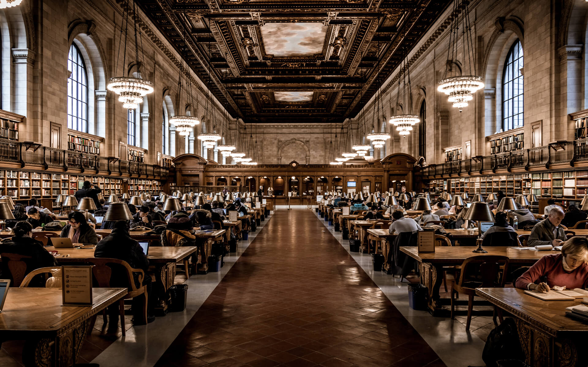 People Studying In Large Library